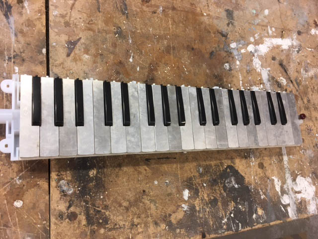 black plastic keys, and aluminium white keys on melodica